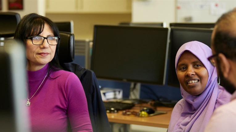 3 PPF colleagues sat near desks talking
