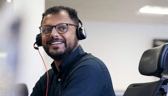 PPF contact team member wearing a headset smiling