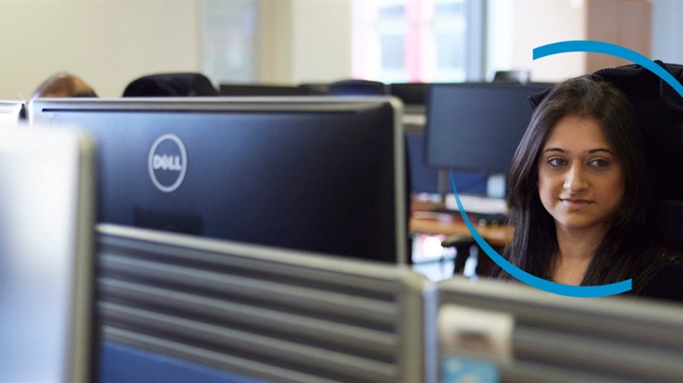 PPF colleague at their desk amongst computer screens