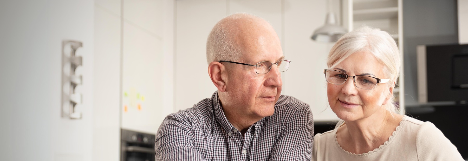 Senior couple sitting in kitchen