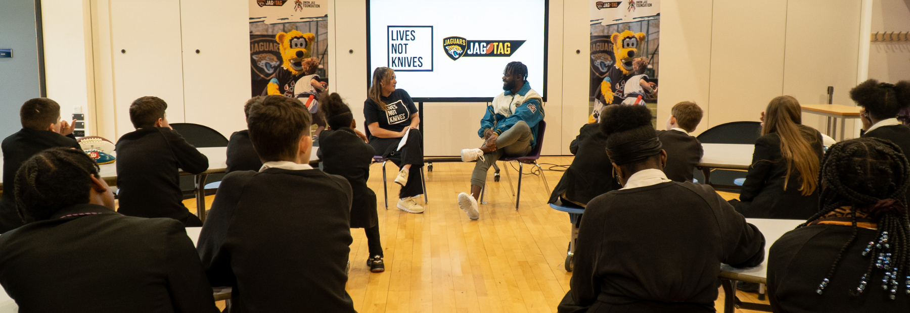 Children in a classroom listening to a presentation from Lives Not Knives