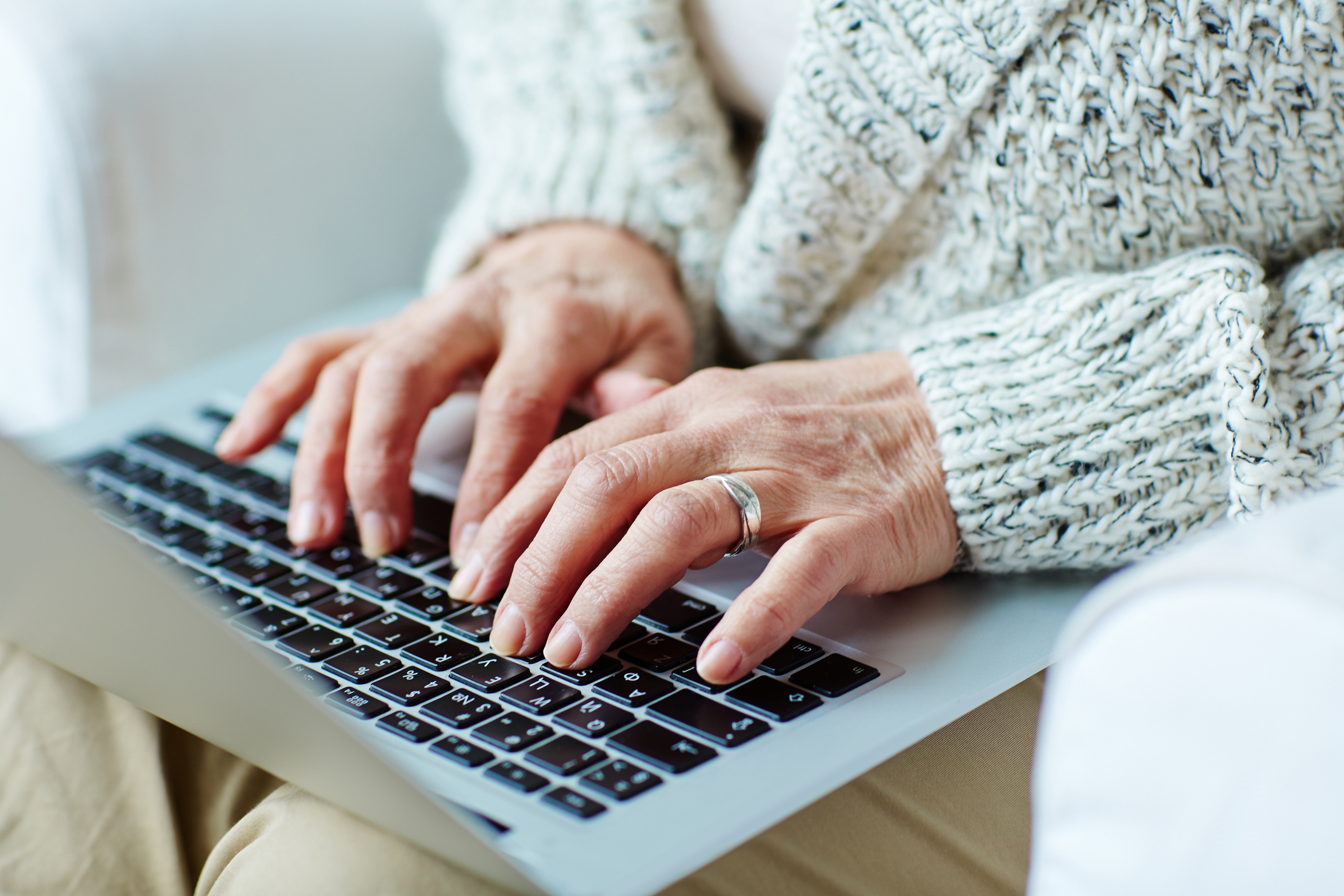 Person typing on laptop keyboard