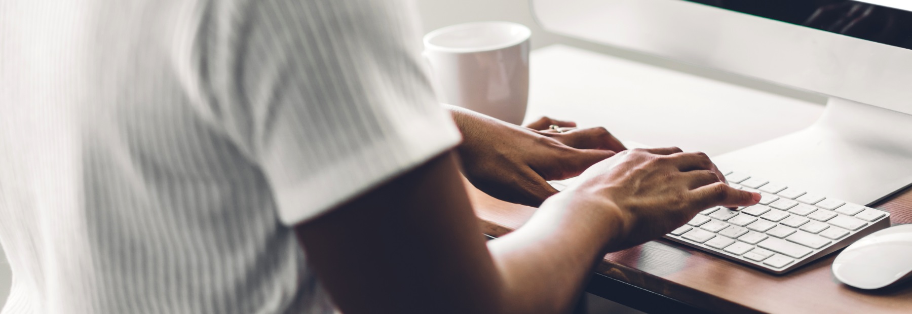 woman typing on computer keyboard