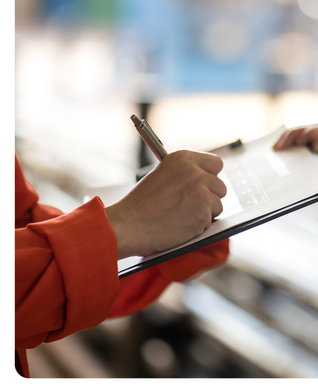 Person writing on clipboard